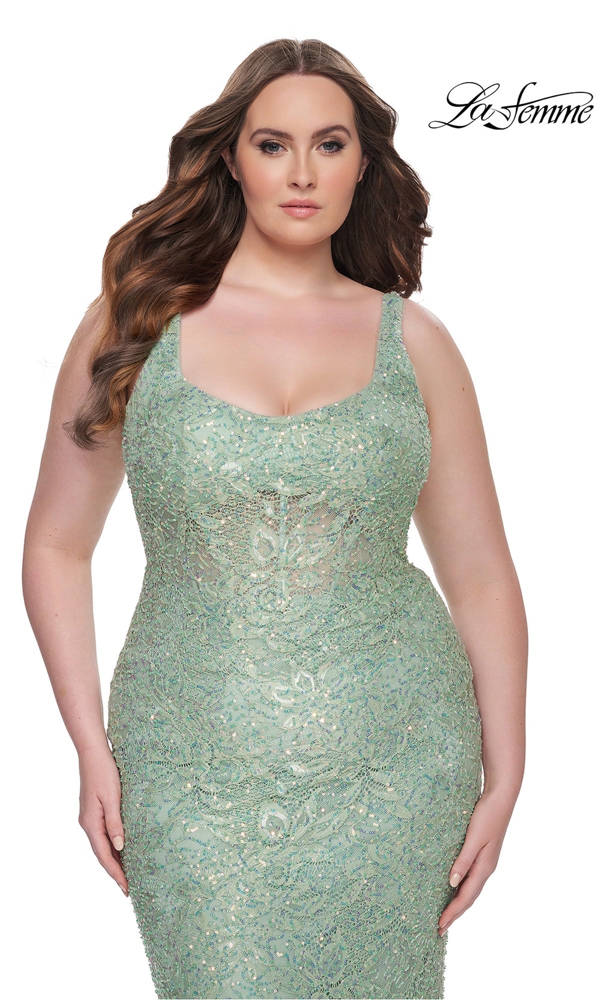 A woman wears the Plus-Size Lace Prom Dress: La Femme 31535 in light green, posing against a white background with the